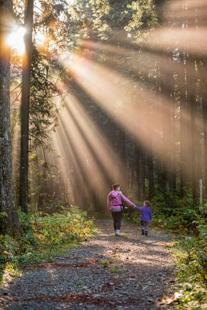 A woman goes for a walk in the woods with her daughter